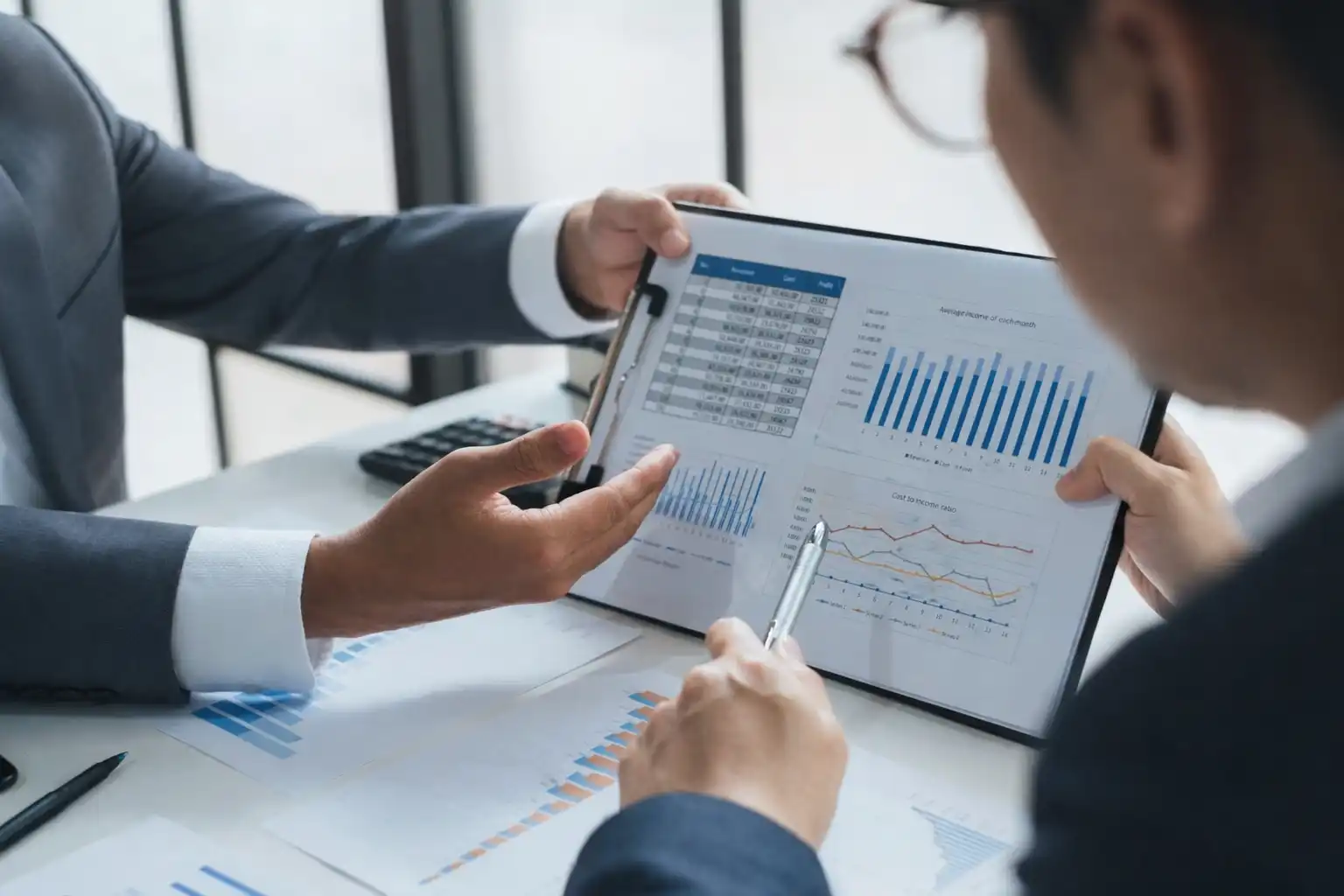 Business professionals reviewing financial charts on a tablet